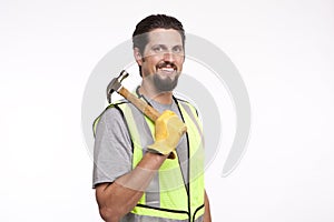 Smiling construction posing with a hammer against white