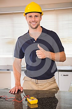 Smiling construction worker giving thumbs up