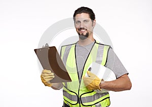 Smiling construction worker posing with a hardhat and clipboard