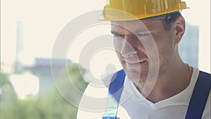 Smiling construction worker smiling and standing on building site