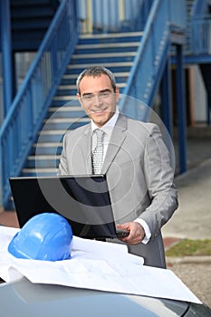 Smiling contractor standing outdoors