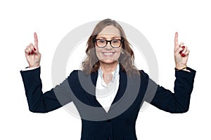 Smiling corporate woman pointing upwards