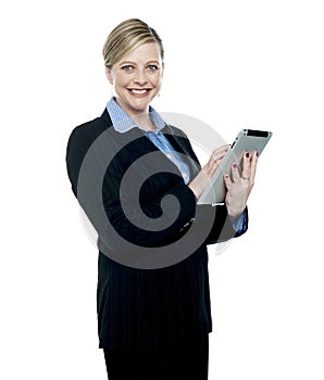 Smiling corporate woman using wireless tablet pc