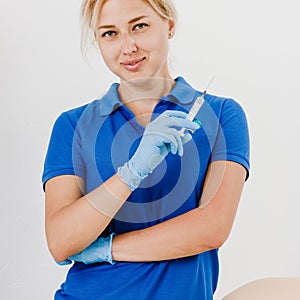 Smiling cosmetician with syringe