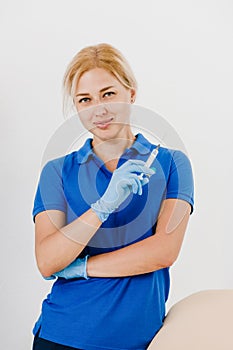 Smiling cosmetician with syringe