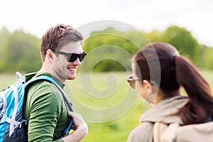 Smiling couple with backpacks in nature