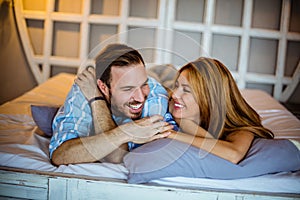 Smiling couple in bed.