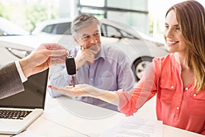 Smiling couple buying a new car