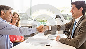 Smiling couple buying a new car photo