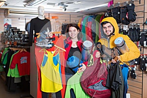 Smiling couple demonstrating new tourist equipment