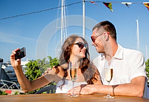 Smiling couple drinking champagne at cafe