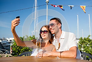 Smiling couple drinking champagne at cafe