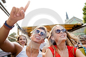 Smiling couple with earphones traveling by bus