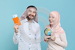 Smiling couple friends arabian muslim man wonam in keffiyeh kafiya ring igal agal hijab clothes isolated on blue