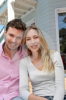 Smiling couple in front of their home