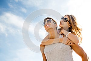 Smiling couple having fun over sky background photo
