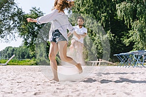 smiling couple having fun and running on sandy