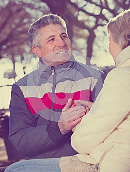 Smiling couple heats palms with each other