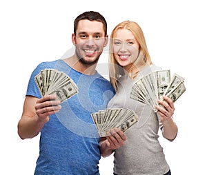 Smiling couple holding dollar cash money