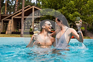 Smiling couple holding glasses of wine