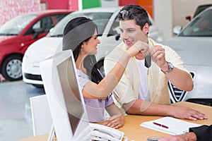 Smiling couple holding their new car key