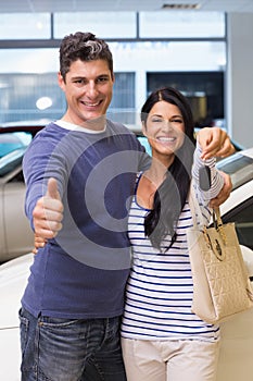 Smiling couple holding their new car key