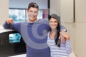 Smiling couple holding their new car key