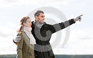 Smiling couple hugging on autumn beach