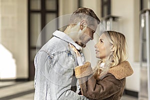 A smiling couple is in love outdoors.A young happy couple embraces on a city street