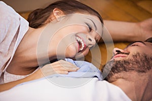 Smiling couple lying on the floor