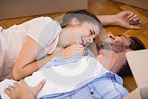 Smiling couple lying on the floor