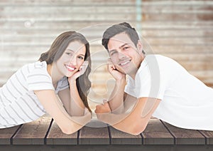 Smiling couple lying on jetty