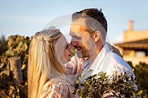 Smiling couple in a mediterranean location about to kiss