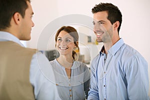 Smiling couple meeting real-estate agent