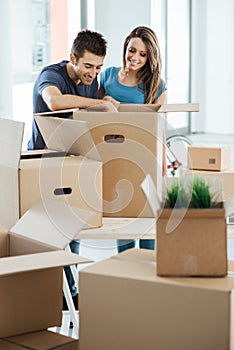 Smiling couple moving in a new house