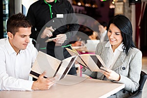 Smiling couple orders a meal