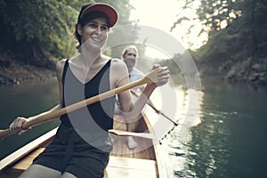 Smiling couple paddling canoe on a forest lake