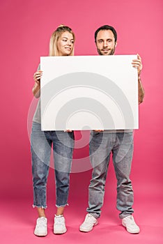 smiling couple posing with empty card, isolated photo