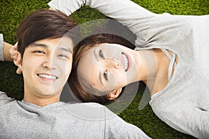 Smiling Couple Relaxing on Green Grass