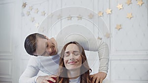 Smiling couple relaxing with massage in christmas decorated room.
