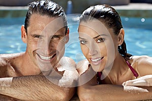 Smiling Couple Relaxing In Swimming Pool