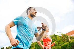 Smiling couple running outdoors