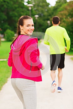 Smiling couple running outdoors