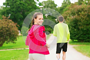 Smiling couple running outdoors