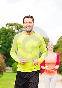 Smiling couple running outdoors