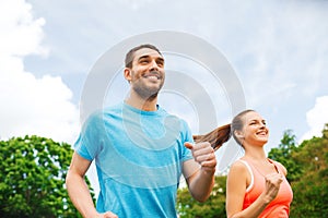 Smiling couple running outdoors