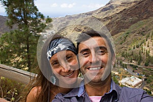 Smiling couple selfie at nature park view point