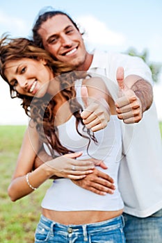 Smiling couple showing thumbs-up