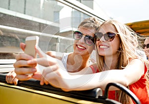 Smiling couple with smartphone making selfie