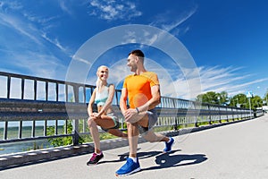 Smiling couple stretching outdoors